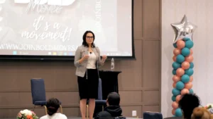 Patti speaking on stage