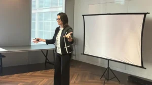 Patti presenting in front of screen