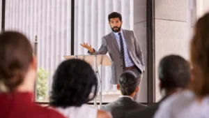 Man at business podium addressing crowd