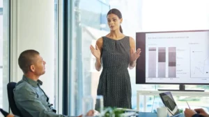 Woman leading business presentation in modern office.