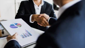 Businessmen shaking hands in office